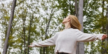 Image of a woman enjoying peacefulness in nature